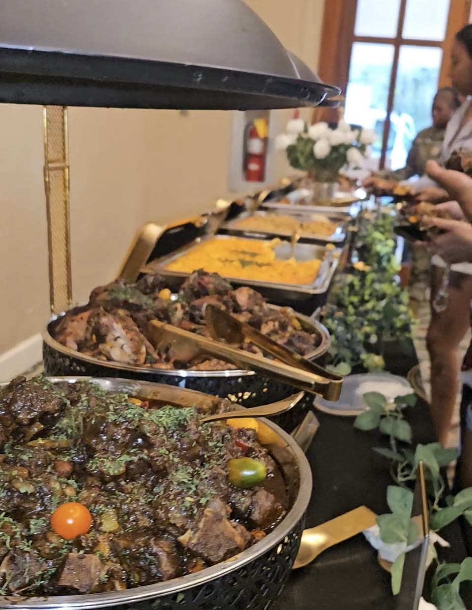 Full gold-and-black chafing dish buffet line at a catered event