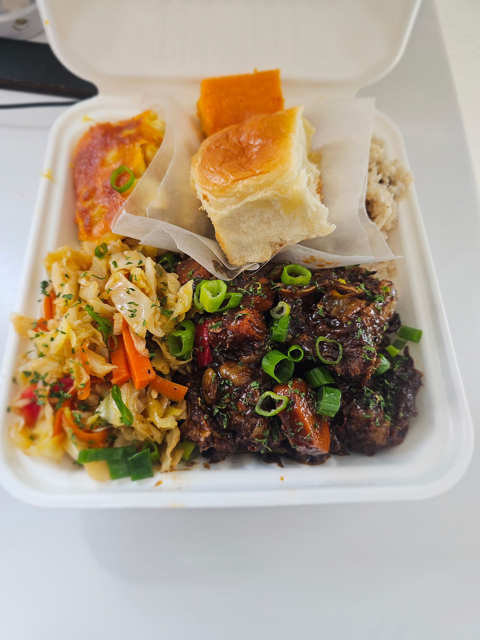 Oxtail plate with roll, sweet potato, cabbage and island coleslaw